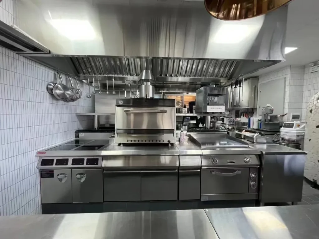 Commercial kitchen with stainless steel appliances and cooking stations