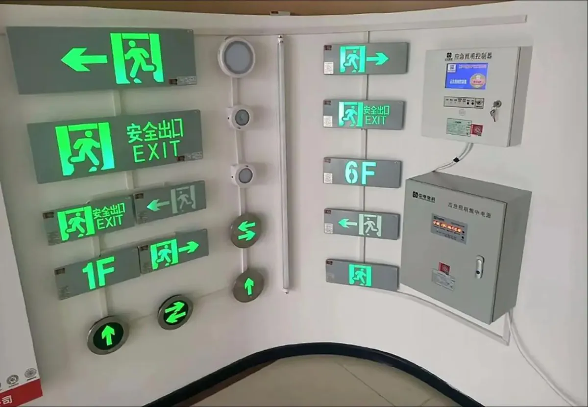 Display of illuminated green emergency exit signs in a hotel corridor highlighting NFPA 101 egress requirements