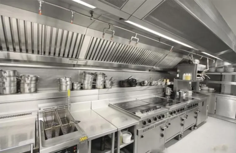 Automatic fire suppression nozzles installed under a commercial kitchen hood